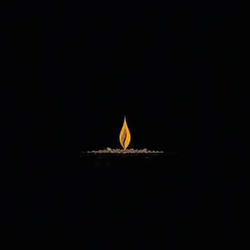 A small steady flame burning above a bed of cold grey ash.