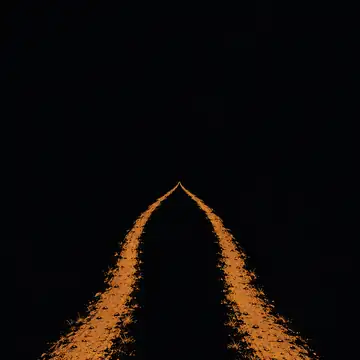 Two worn footpaths across a plain, meeting at a single light on the horizon.